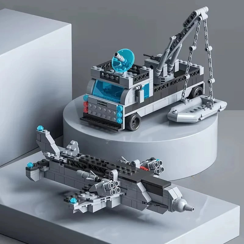 Toy truck with crane and boat on a gray platform