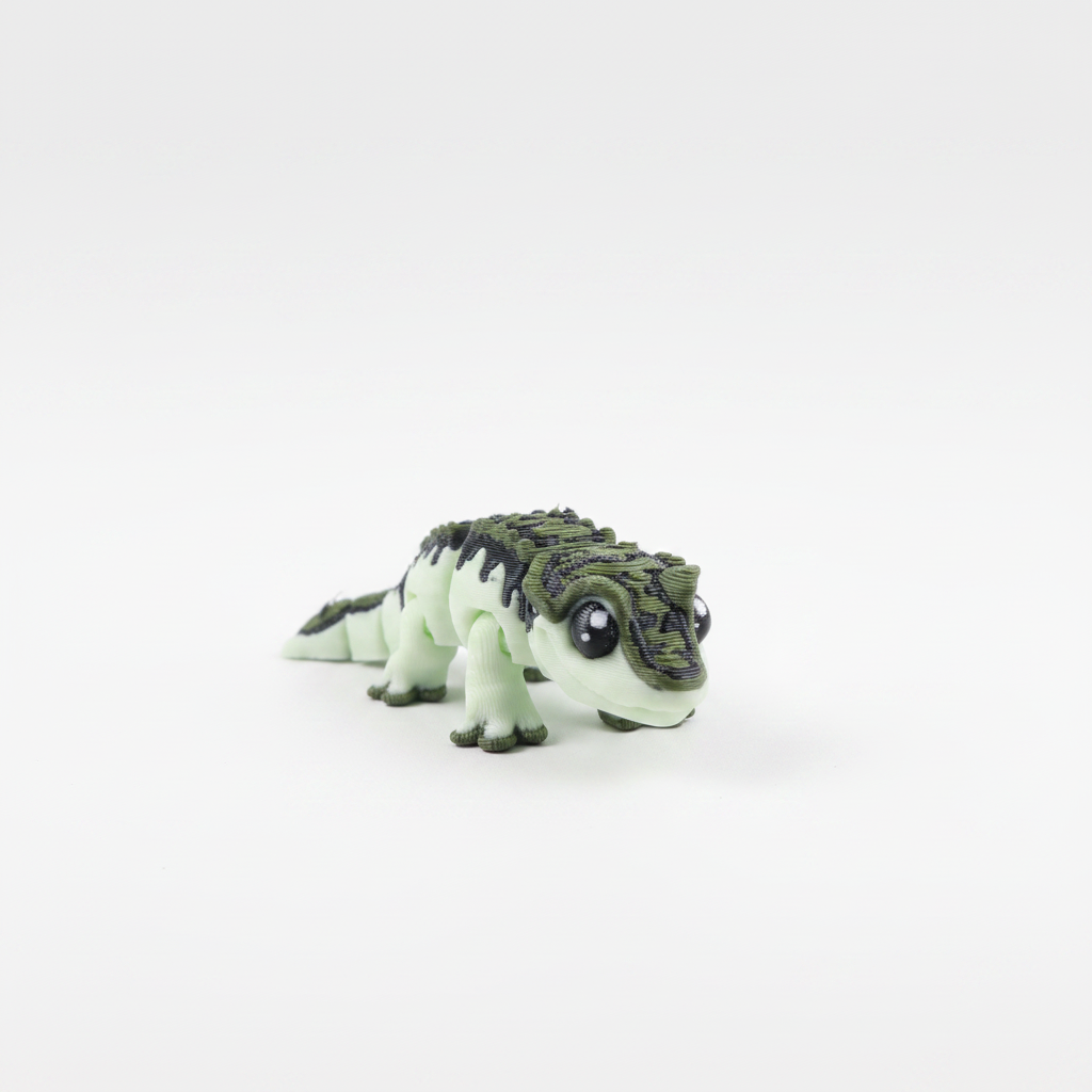 Green and white alligator fidget toy on white background